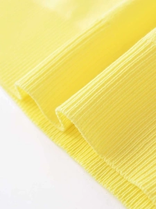 Detail view of the yellow ribbed knit fabric showing the soft texture and vertical patterns