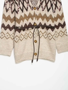 Detailed close-up of vintage jacquard knit cardigan with subtle sequins and belt detail
