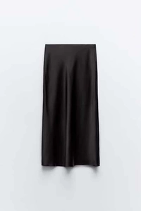 Detailed view of black satin midi skirt featuring smooth glossy fabric and elegant drape