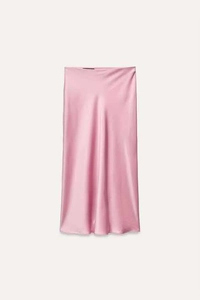 Detail shot of smooth pink satin midi skirt fabric with glossy finish and clean cut