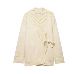 Detailed view of the rib-knit cuffs and delicate hollow-out pattern on the cream cardigan