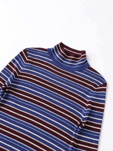 Close-up of fine knit texture on striped high-neck sweater with burgundy and blue tones