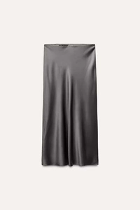 Detailed view of silver grey satin skirt texture with smooth silky fabric and waist label