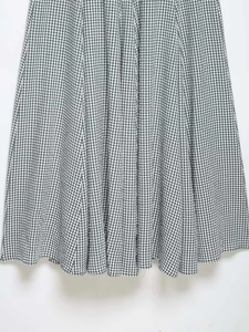 Detailed view of black and white gingham dress hem with textured lightweight fabric