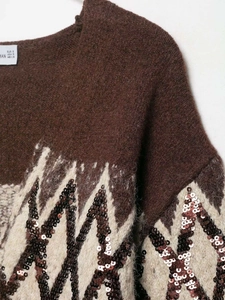 Detail of V-neck brown knit sweater with sequined geometric patterns and inner tag
