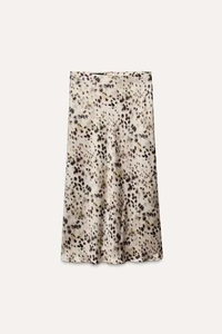 Detailed macro shot of satin midi skirt fabric with stylish leopard animal print