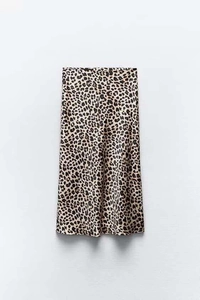 Detailed close-up of leopard print satin midi skirt showing smooth fabric texture and drape