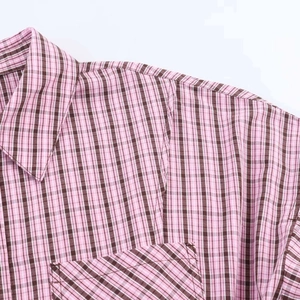 Detail of classic pink and brown checkered shirt showing pointed collar and chest pocket