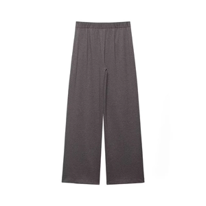 Close-up of dark grey textured wide-leg trousers with elastic waistband and vertical pleats