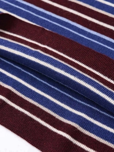 Close-up of three-color striped knit fabric showing red blue and white ribbed texture