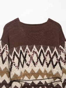 Detail view of brown knit sweater featuring metallic sequin chevron patterns and slim belt