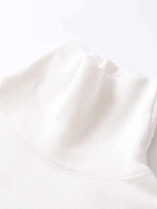 Detailed close-up of white high-neck knitted fabric texture and premium stitching detail