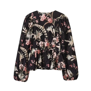 Vintage floral long sleeve blouse with puff sleeves and peplum hem on white background