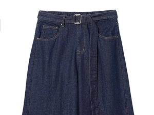 Close-up of deep blue denim jeans featuring a matching belt with a silver square metal buckle