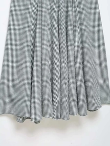 Detailed close-up showing black and white gingham pattern with pleated fabric texture