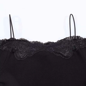 Detailed close-up of floral lace neckline and ribbed knit texture on black camisole top