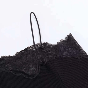 Close-up of black ribbed knit fabric with delicate floral lace trim and spaghetti straps