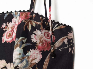 Detail of floral summer dress with beaded neckline and gemstone strap charms
