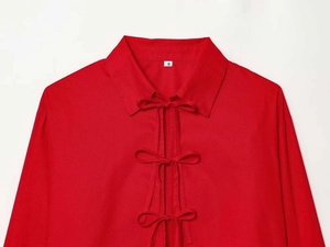 Detail of red shirt featuring three front bow ties and a classic collar design