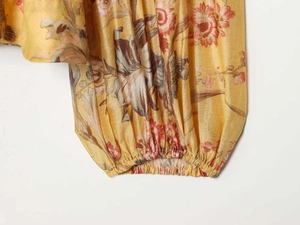 Detailed close-up of elastic cuffs on a yellow vintage floral print puff sleeve blouse