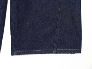 Detail of dark blue denim hem with contrast yellow stitching and twill texture