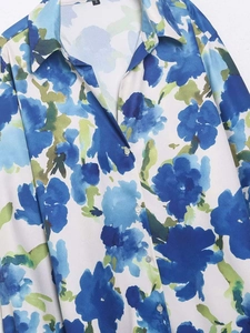 Detailed macro view of floral print satin fabric with collar and white resin buttons