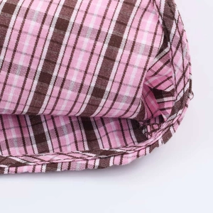 Detailed macro view showing the hem stitching and pink plaid fabric of the shirt