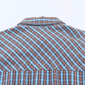 Detail of blue and brown plaid dress showing back yoke diagonal seam and fine stitching