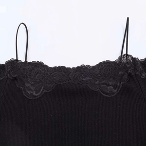 Detail shot of black knitted rib fabric with delicate floral lace trim and slim straps
