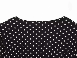 Detailed macro view of the neckline and fabric on the black white polka dot dress