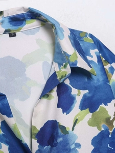 Detailed close-up of blue and green abstract floral print on satin shirt neckline