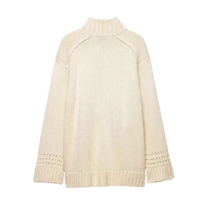 Chic cream white wrap knit cardigan featuring a cross-neck design and hollow-out cuffs