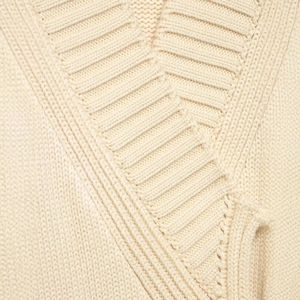 Chic cream-colored rib-knit wrap cardigan with cozy thick texture and cross-tie neckline