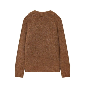 Detail view of the raglan sleeves and ribbed knit texture on the back of the brown sweater