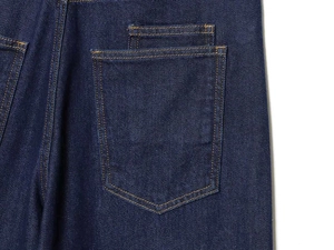 Close-up of deep blue denim back pocket with vintage yellow contrast stitching detail