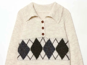 Close-up of a beige diamond-pattern knit sweater with polo collar and three dark buttons