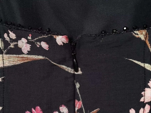 Close-up of invisible zipper and floral fabric with beaded trim on a summer dress