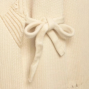 Chic beige knit cardigan featuring a side-tie bow detail and soft woven texture