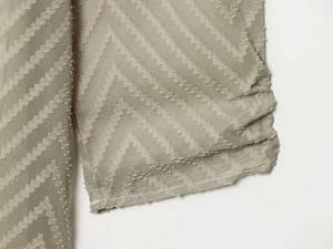 Macro shot of apricot pleated fabric with chic zigzag texture and light chiffon finish