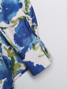Detailed close-up of blue floral satin shirt cuff with premium stitching and silky texture