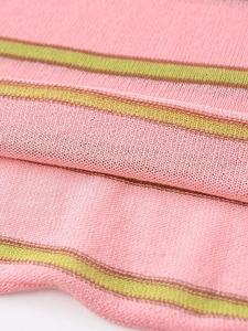 Close-up of pink and yellow striped knit fabric with soft texture and breathable weave