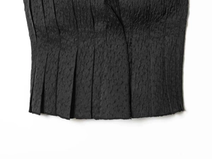Close-up of charcoal black pleated fabric texture showing intricate vertical褶 wrinkles