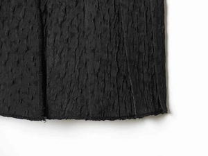 Detailed view of black pleated fabric texture with a 3D crinkle effect and fine stitching