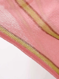 Close-up of pink knit mesh fabric featuring contrasting yellow and green stripe details