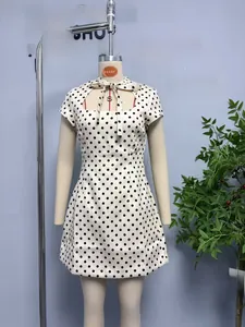 Detail of white polka dot short dress with bow tie neckline and high waist A-line cut