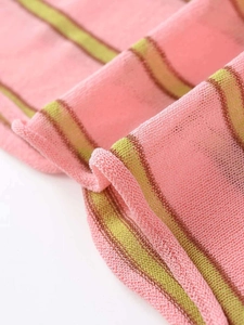 Detail shot of the lightweight pink and green striped knit fabric with breathable texture