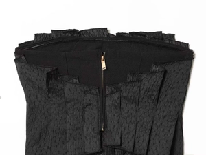 Close-up of black textured tube top featuring a golden metal zipper and non-slip inner grip