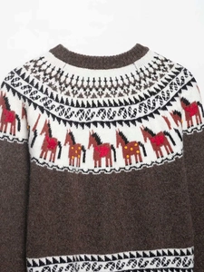Détail du pull en maille Fair Isle avec jacquard de poney brun et encolure en maille côtelée