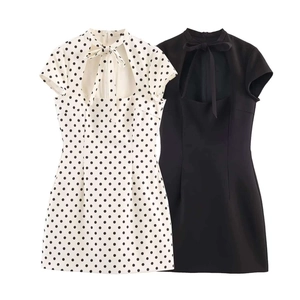 Detail of high collar with bow tie and teardrop cutout on chic short sleeve mini dress