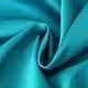 Detail shot of peacock blue silk fabric with glossy finish and elegant soft drapery folds